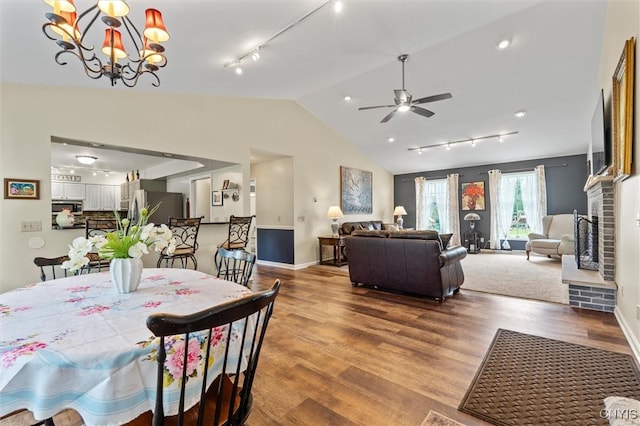331 Hickory Ln, Hastings, NY 13036 - dining space featuring rail lighting, lofted ceiling, ceiling fan, wood finished floors, and a chandelier