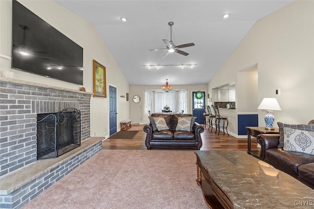 331 Hickory Ln, Hastings, NY 13036 - living room with a brick fireplace, ceiling fan, track lighting, wood finished floors, and high vaulted ceiling