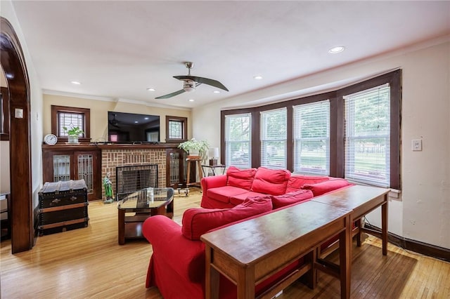 108 Iroquois St, Rochester, NY 14609 - living room with light wood-type flooring, healthy amount of natural light, a ceiling fan, crown molding, and a brick fireplace