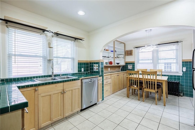108 Iroquois St, Rochester, NY 14609 - kitchen with stainless steel dishwasher, light brown cabinets, tile walls, healthy amount of natural light, and tile counters