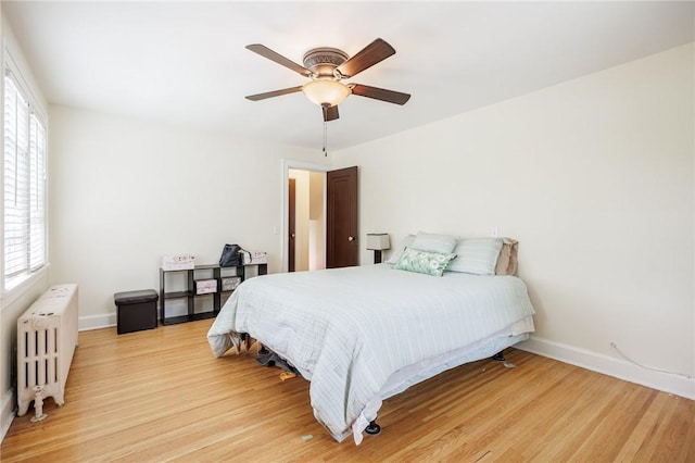 108 Iroquois St, Rochester, NY 14609 - bedroom featuring radiator, light wood-style floors, and ceiling fan