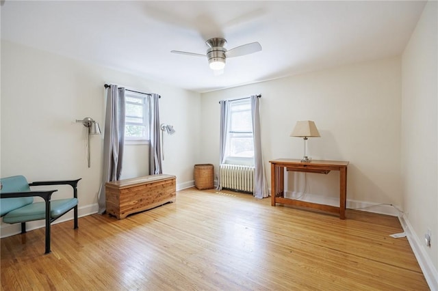 108 Iroquois St, Rochester, NY 14609 - sitting room with radiator, a ceiling fan, and light wood-style floors