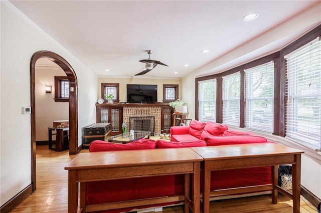 108 Iroquois St, Rochester, NY 14609 - living room with wood finished floors, arched walkways, a brick fireplace, recessed lighting, and a ceiling fan