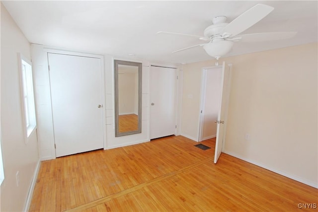32 Franklin St, Champion, NY 13619 - unfurnished bedroom featuring multiple closets, light wood-type flooring, and a ceiling fan
