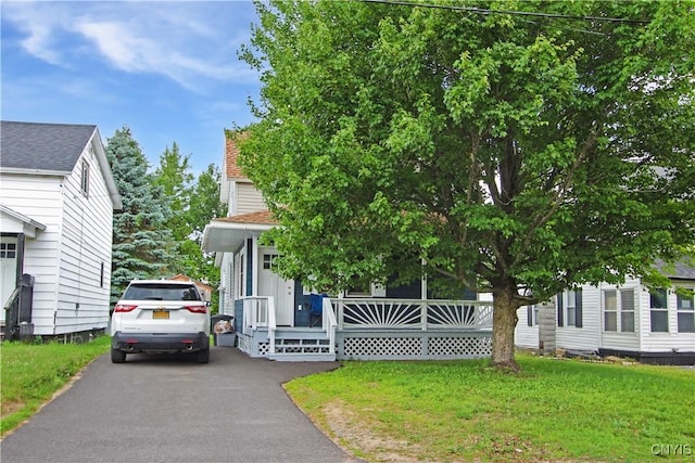 32 Franklin St, Champion, NY 13619 - view of property hidden behind natural elements with a front yard, a porch, and a shingled roof