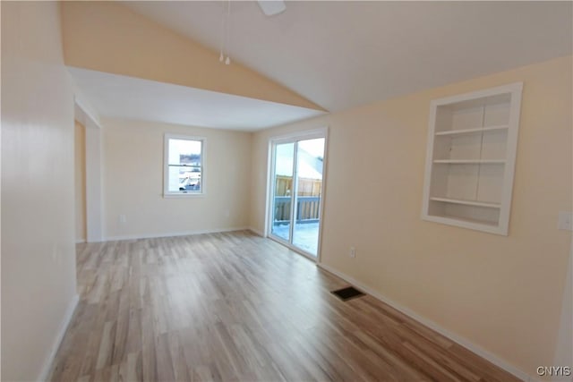 32 Franklin St, Champion, NY 13619 - spare room with vaulted ceiling, wood finished floors, and built in features