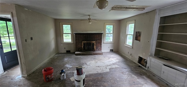 76 Deacon Rd, Orchard Park, NY 14127 - unfurnished living room featuring ceiling fan and a brick fireplace