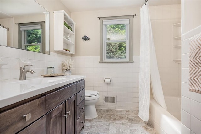 500 Watson Rd, Perinton, NY 14450 - bathroom featuring tile walls, vanity, plenty of natural light, shower / bathtub combination with curtain, and a wainscoted wall