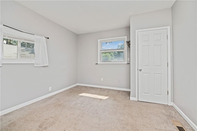 1084 Plymouth Ave S, Rochester, NY 14608 - unfurnished bedroom with multiple windows and carpet floors