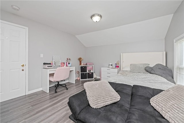 1084 Plymouth Ave S, Rochester, NY 14608 - bedroom with lofted ceiling, wood finished floors, and a desk