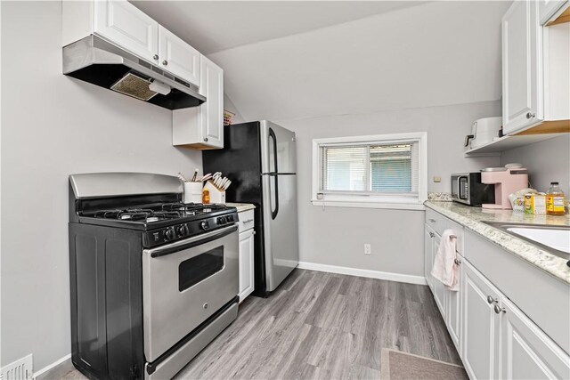 1084 Plymouth Ave S, Rochester, NY 14608 - kitchen featuring appliances with stainless steel finishes, under cabinet range hood, white cabinets, lofted ceiling, and light wood-style floors