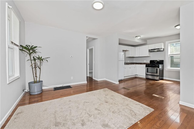1084 Plymouth Ave S, Rochester, NY 14608 - unfurnished living room with baseboards and dark wood-type flooring