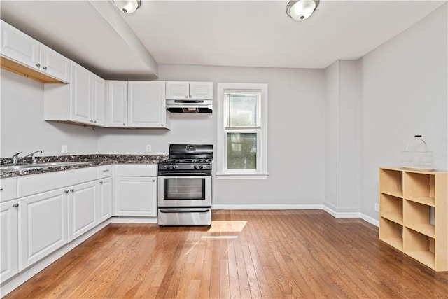 1084 Plymouth Ave S, Rochester, NY 14608 - kitchen with stainless steel gas range oven, under cabinet range hood, light wood-style flooring, and white cabinets