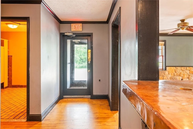 1369 Pittsford Mendon Rd, Mendon, NY 14506 - doorway featuring ornamental molding, a ceiling fan, a textured ceiling, and light wood-style floors
