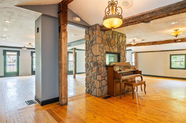 1369 Pittsford Mendon Rd, Mendon, NY 14506 - living room with beam ceiling, wood-type flooring, and decorative columns