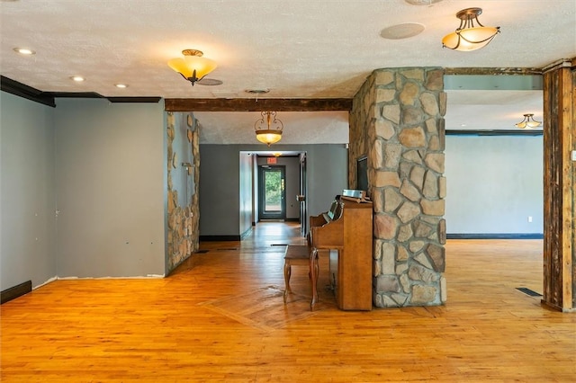 1369 Pittsford Mendon Rd, Mendon, NY 14506 - hall featuring decorative columns, wood finished floors, and a textured ceiling