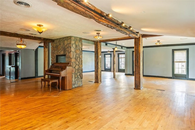 1369 Pittsford Mendon Rd, Mendon, NY 14506 - living room featuring light wood-style flooring, beamed ceiling, and a textured ceiling