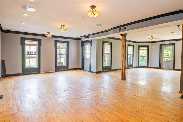 1369 Pittsford Mendon Rd, Mendon, NY 14506 - empty room with ornamental molding, decorative columns, and light wood-type flooring