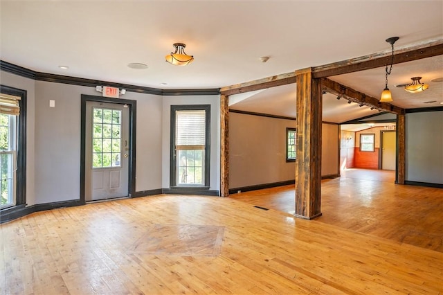 1369 Pittsford Mendon Rd, Mendon, NY 14506 - empty room featuring ornamental molding, plenty of natural light, light wood-type flooring, a smoke detector, and beam ceiling