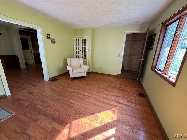 237 E Hamilton Ave, Sherrill, NY 13461 - unfurnished room featuring a textured ceiling, light wood-type flooring, and french doors