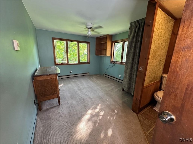 237 E Hamilton Ave, Sherrill, NY 13461 - unfurnished bedroom with a baseboard heating unit, carpet floors, and ceiling fan