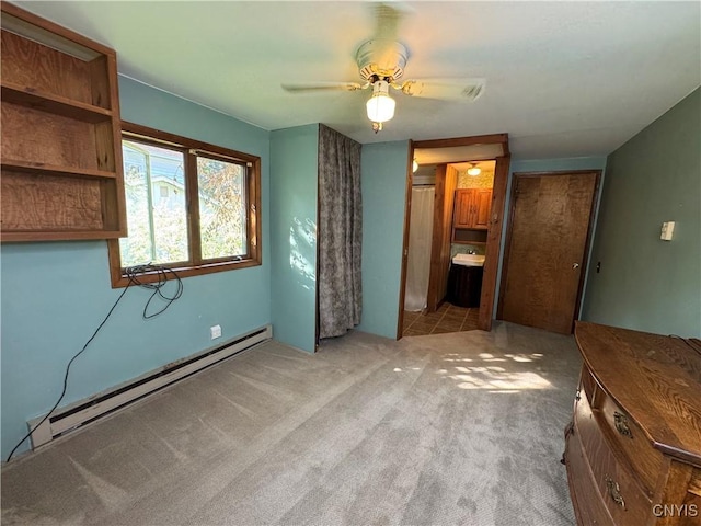 237 E Hamilton Ave, Sherrill, NY 13461 - unfurnished bedroom featuring a baseboard heating unit, carpet flooring, ensuite bathroom, and a ceiling fan