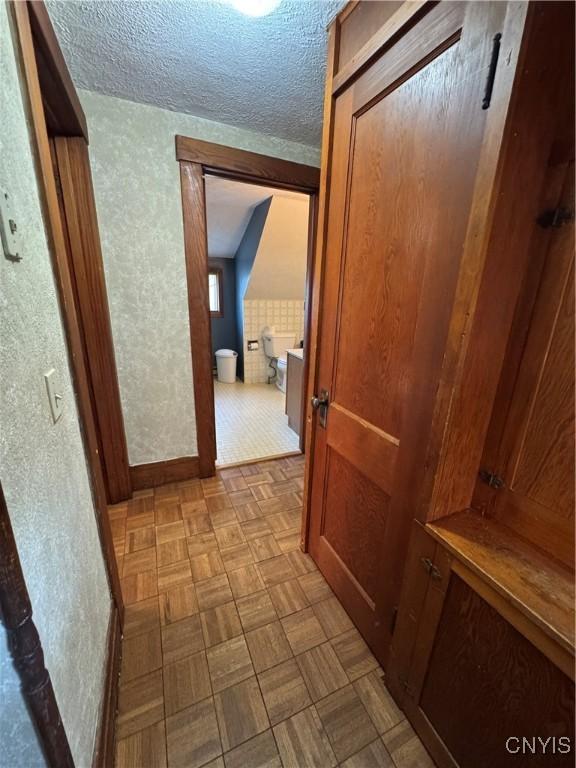 237 E Hamilton Ave, Sherrill, NY 13461 - hallway with a textured ceiling and baseboards