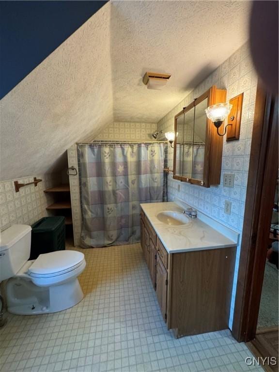 237 E Hamilton Ave, Sherrill, NY 13461 - bathroom with a textured ceiling, lofted ceiling, vanity, curtained shower, and wallpapered walls