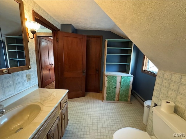 237 E Hamilton Ave, Sherrill, NY 13461 - bathroom with a textured ceiling, a baseboard radiator, lofted ceiling, vanity, and tile patterned floors