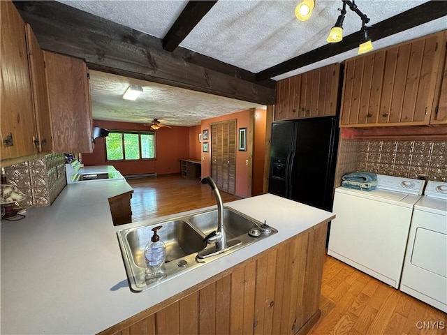 237 E Hamilton Ave, Sherrill, NY 13461 - kitchen with black fridge, washer and clothes dryer, light wood-style flooring, ceiling fan, and beam ceiling