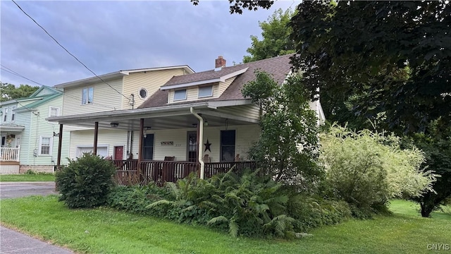 237 E Hamilton Ave, Sherrill, NY 13461 - view of front facade with covered porch, a chimney, a shingled roof, and a front yard