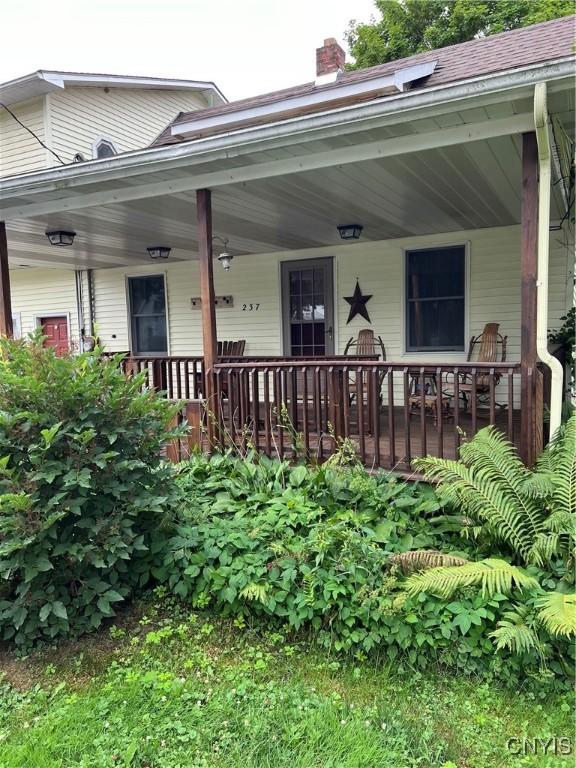 237 E Hamilton Ave, Sherrill, NY 13461 - doorway to property featuring a chimney and a porch