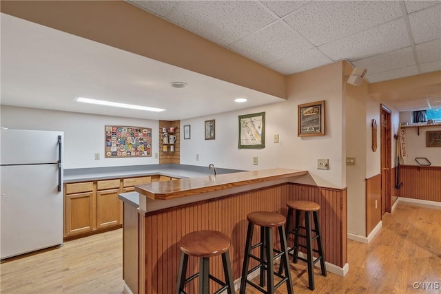 1705 Lancelot Pl, Skaneateles, NY 13152 - indoor wet bar with freestanding refrigerator, light wood finished floors, and wainscoting
