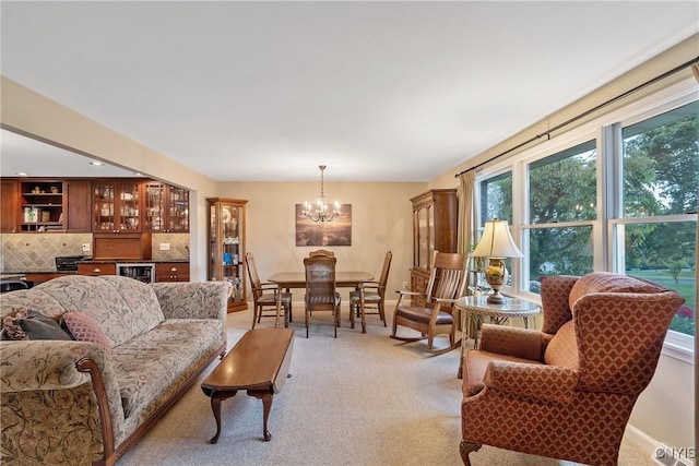 1705 Lancelot Pl, Skaneateles, NY 13152 - living area featuring plenty of natural light, a chandelier, beverage cooler, and light carpet