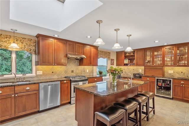 1705 Lancelot Pl, Skaneateles, NY 13152 - kitchen with wine cooler, appliances with stainless steel finishes, decorative backsplash, brown cabinets, and recessed lighting