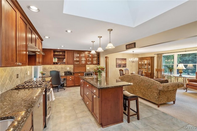 1705 Lancelot Pl, Skaneateles, NY 13152 - kitchen featuring stainless steel appliances, brown cabinetry, a breakfast bar area, under cabinet range hood, and recessed lighting