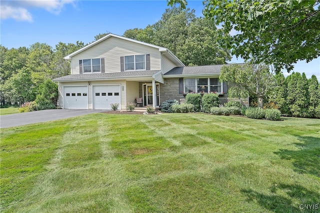 1705 Lancelot Pl, Skaneateles, NY 13152 - view of front of home featuring driveway, a garage, a front lawn, and stone siding