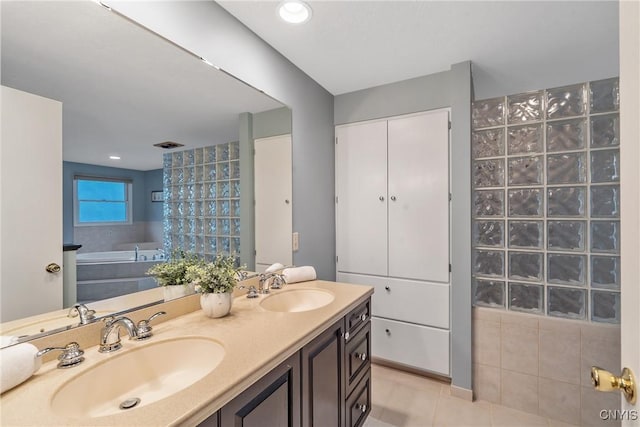 1705 Lancelot Pl, Skaneateles, NY 13152 - full bathroom featuring double vanity, tile patterned flooring, and a garden tub