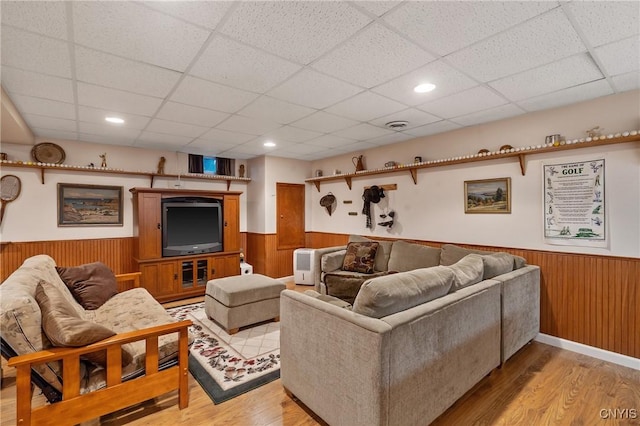 1705 Lancelot Pl, Skaneateles, NY 13152 - living room featuring wainscoting, a paneled ceiling, light wood-style floors, and wooden walls