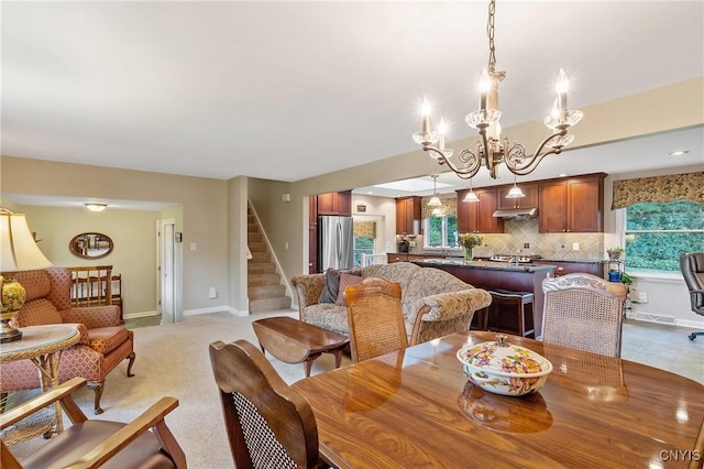 1705 Lancelot Pl, Skaneateles, NY 13152 - dining space featuring stairs and a chandelier