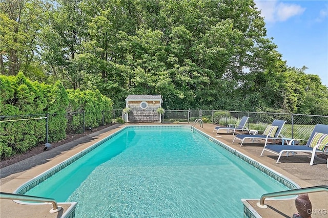 1705 Lancelot Pl, Skaneateles, NY 13152 - community pool with a fenced backyard, a patio, view of wooded area, and a shed