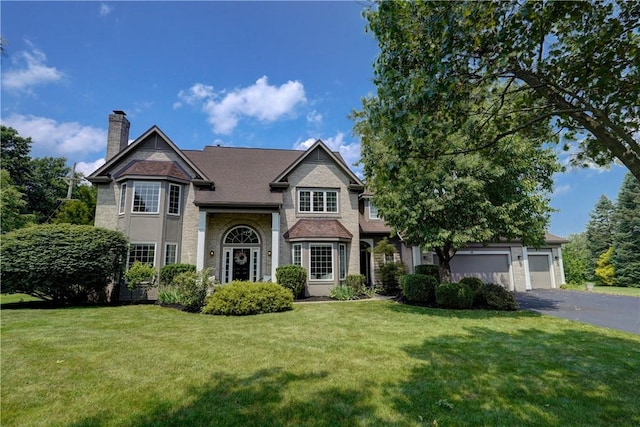 10 Muirfield Ct, Pittsford, NY 14534 - view of front of property featuring asphalt driveway, a chimney, a front lawn, and an attached garage