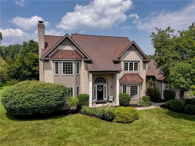 10 Muirfield Ct, Pittsford, NY 14534 - view of front of home with a chimney, a front yard, brick siding, and roof with shingles