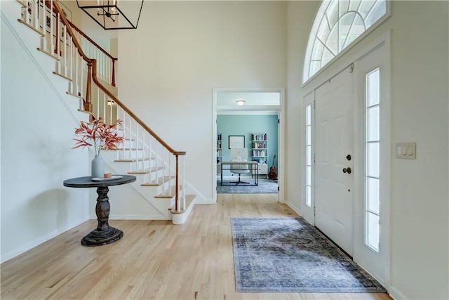 10 Muirfield Ct, Pittsford, NY 14534 - foyer entrance with a towering ceiling, stairs, wood finished floors, and a chandelier