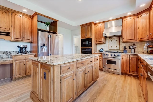10 Muirfield Ct, Pittsford, NY 14534 - kitchen featuring premium appliances, wall chimney range hood, light wood-style flooring, light stone countertops, and a kitchen island