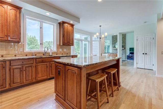 10 Muirfield Ct, Pittsford, NY 14534 - kitchen with light wood-style floors, brown cabinets, light stone counters, and recessed lighting