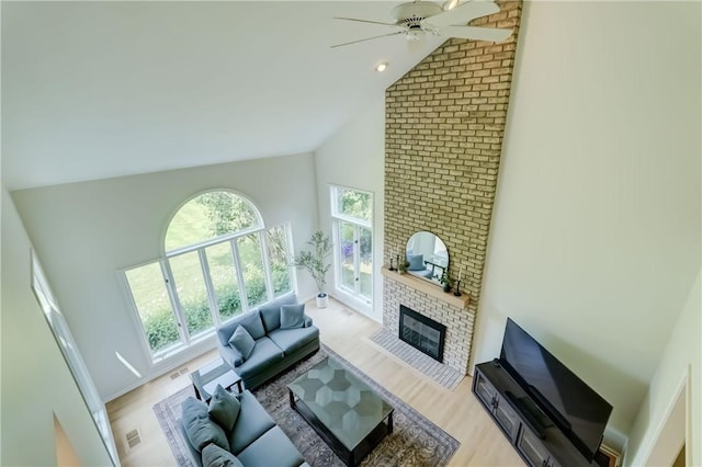 10 Muirfield Ct, Pittsford, NY 14534 - living room featuring high vaulted ceiling, light wood finished floors, a ceiling fan, and a brick fireplace