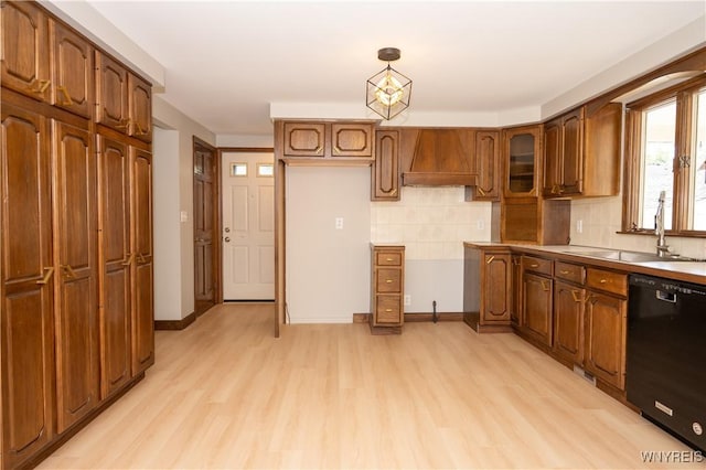92 Schiller St, Buffalo, NY 14206 - kitchen with black dishwasher, light wood-style floors, tasteful backsplash, and brown cabinetry