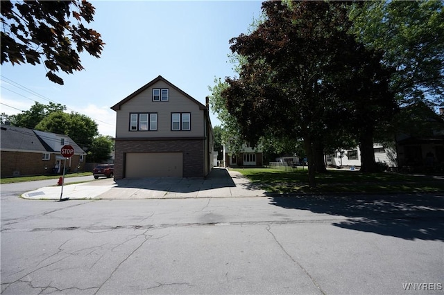 92 Schiller St, Buffalo, NY 14206 - view of front of property featuring an attached garage, driveway, and brick siding