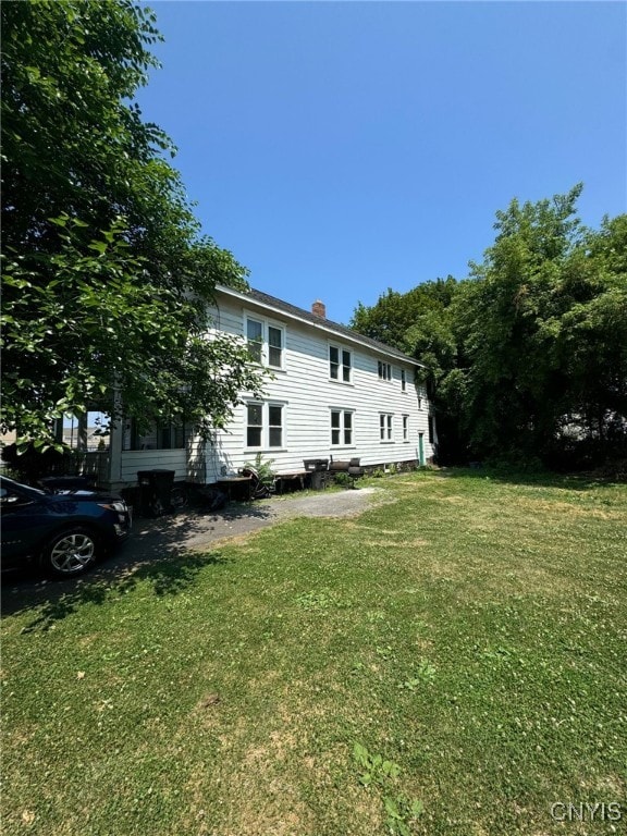 152 Fage Ave Unit 54, Syracuse, NY 13205 - rear view of property featuring a lawn and a chimney